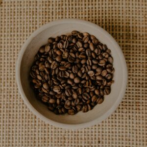 Roasted coffee beans in a small bowl