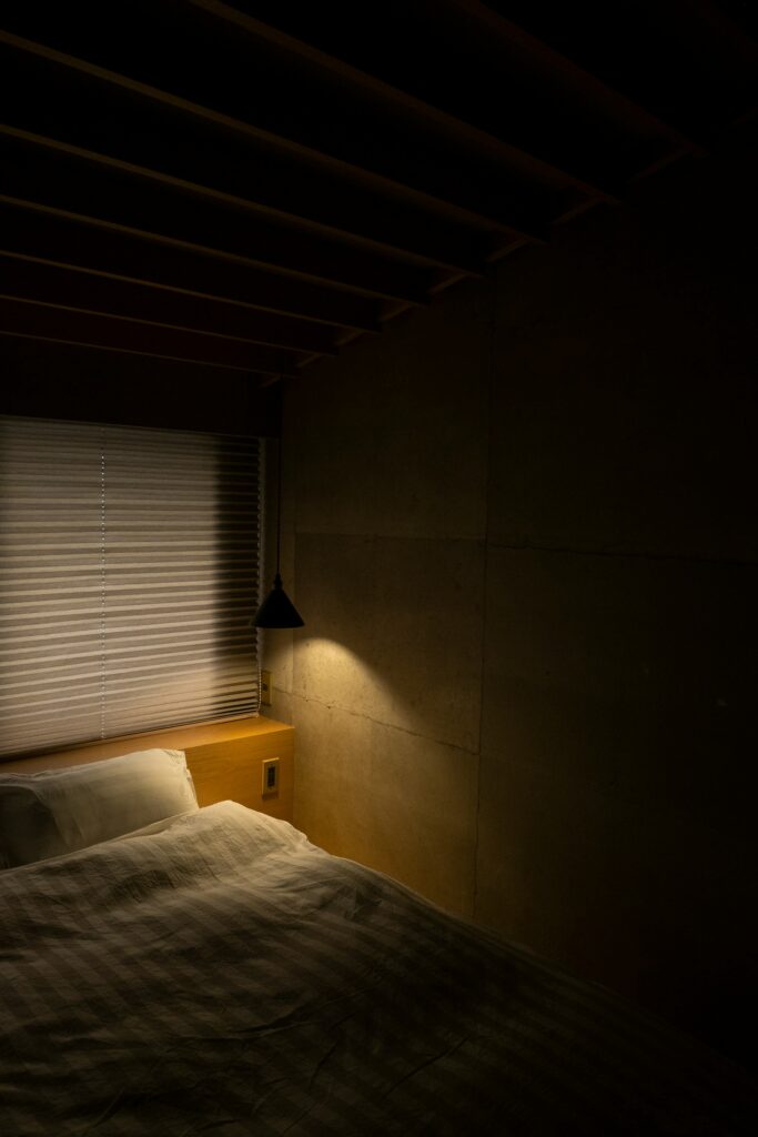 White bed near a bright window